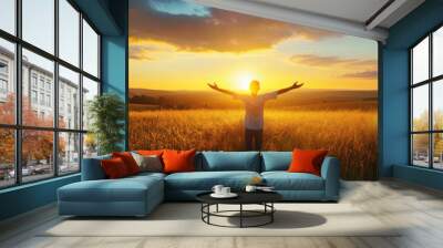 A person is standing in a field with the sun shining on them Wall mural