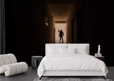 Dark corridor with cabinet doors and lights with silhouette of spooky horror man standing with different poses. Wall mural