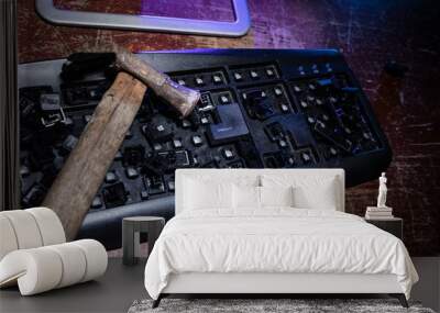 Hammer on computer keyboard with damaged keys Wall mural