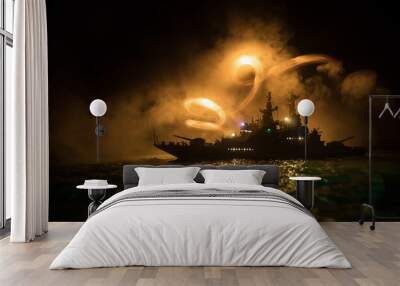 Silhouettes of a crowd standing at blurred military war ship on foggy background. Selective focus. Wall mural