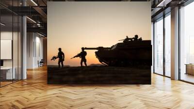 War Concept. Armored vehicle silhouette fighting scene on war fog sky background. American tank at sunset. Wall mural