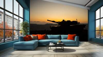 War Concept. Armored vehicle silhouette fighting scene on war fog sky background. American tank at sunset. Wall mural