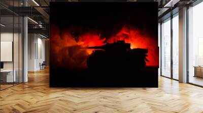 War Concept. Military silhouettes fighting scene on war fog sky background, German tank in action Below Cloudy Skyline At night. Attack scene. Armored vehicles Wall mural