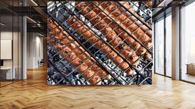 Brazier with hot coals. The process of making sausages on the grill. Relax in nature. Weekend Wall mural