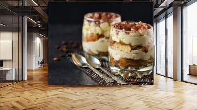 Classic tiramisu in a glass jar on a black background  Wall mural