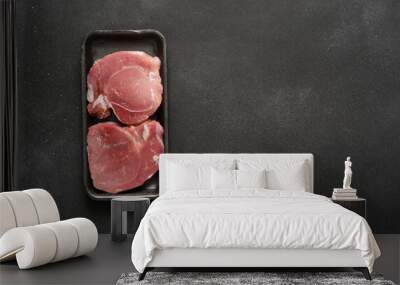 Fresh raw meat in a tray on a black background, pork Wall mural