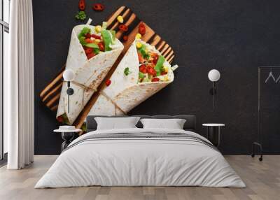 Mexican tortilla with beef, vegetables and chili on a dark background. Wall mural