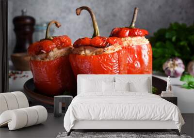 The traditional dish is stuffed peppers with pork and rice on a light concrete background. Wall mural