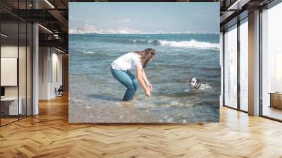 girl with dog on the beach Wall mural