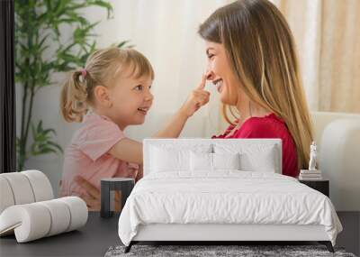 Happy mother and daughter at home Wall mural