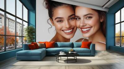 Two smiling women showcasing natural beauty in white dresses Wall mural