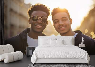 Two young men smiling in sunny Paris cityscape. Wall mural