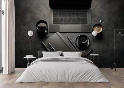 Monochromatic black office desk setup featuring a laptop, smartphone, notebooks, and a coffee mug, ideal for modern professionals. Wall mural