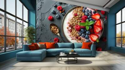 A bowl of fruit and granola with a spoon in it Wall mural