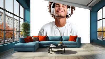 A man with curly hair is wearing headphones and smiling. Concept of relaxation and happiness Wall mural