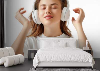 A woman wearing headphones and smiling. Concept of relaxation and enjoyment as the woman listens to music Wall mural