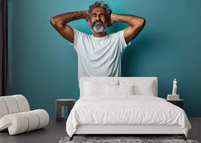 Stressed indian man in white t shirt showing frustration Wall mural