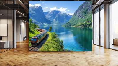 The train is surrounded by lush green trees and the landscape is serene Wall mural