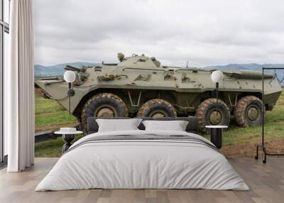 Russian armored personnel carrier in green camouflage attached to a tractor Wall mural