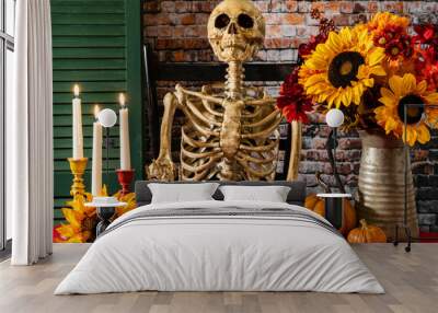 fall skeleton sitting at table eating gingerbread cookies surrounded by pumpkins and sunflowers Wall mural