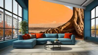 Abstract tree trunk against orange sand dunes, desert landscape in Namib-Naukluft National Park Namibia, Africa Wall mural