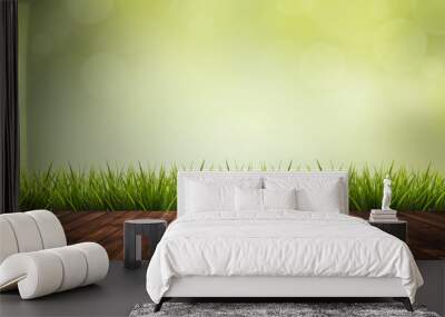 Wooden floor, grass and green blurred background Wall mural