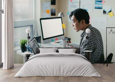 asian man working at a comptuer Wall mural