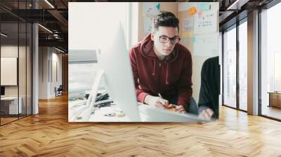 two men working togehter in a small home office. Wall mural