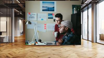 two people collaborating around a computer Wall mural