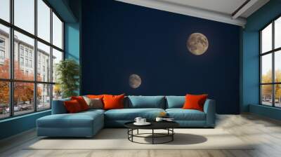 Two full moons are in the sky, one is on the left and the other is on the right Wall mural