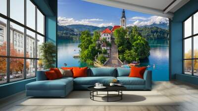 Bled, Slovenia - Aerial view of beautiful Pilgrimage Church of the Assumption of Maria on a small island at Lake Bled (Blejsko Jezero) and lots of Pletna boats on the lake at summer time with blue sky Wall mural