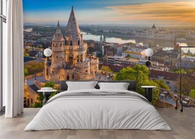 Budapest, Hungary - Beautiful golden summer sunrise with the tower of Fisherman's Bastion and green trees. Parliament of Hungary and River Danube at background. Blue sky. Wall mural