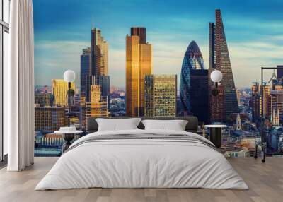 London, United Kingdom - The bank district of central London with famous skyscrapers in golden shine and other landmarks at sunset with blue sky Wall mural