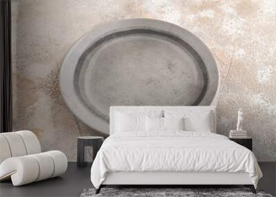 Empty gray ceramic plate on gray concrete background. Side view, copy space Wall mural