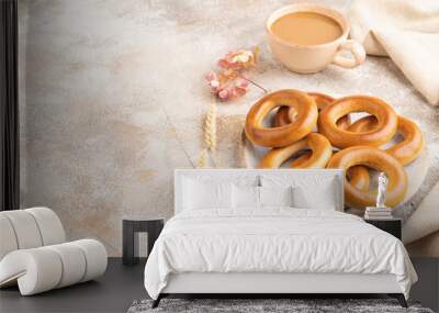 Homemade Ring Bagel with cup of coffee on brown concrete background, side view, copy space. Wall mural