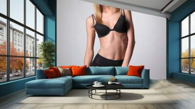 young slim woman in pantyhose and bra Wall mural