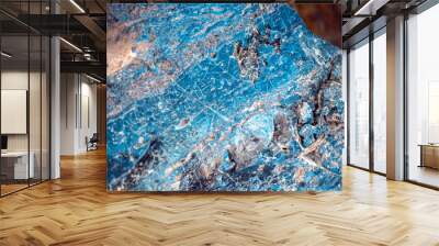 A blue natural stone with lots of details closeup, a piece of volcanic origin stone. Wall mural