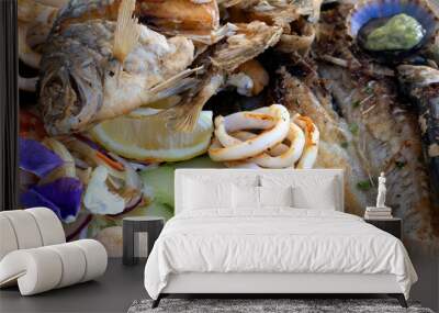 A grilled fish mix plate with various types of fish, seafood, scallops and squid rings. Wall mural