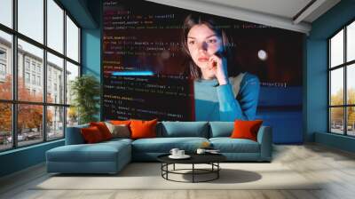 girl works on a laptop at night, coding and creating project. Wall mural