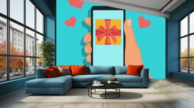 Phone in hand, gift on the phone screen Wall mural