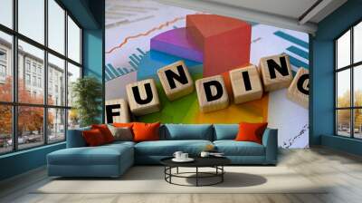 The concept of the word funding on cubes against the background of the graph Wall mural