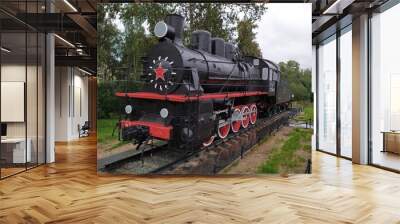 Vintage military black steam locomotive on rails Wall mural