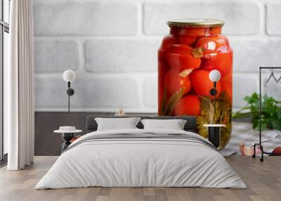 Pickled tomatoes in a glass jar. Homemade. Wall mural