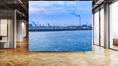 Petrochemical plant and solar panels industrial equipment and river landscape at sunset Wall mural