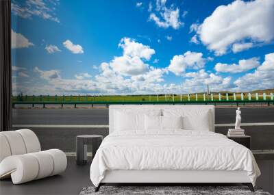 Empty highway, blue sky and white clouds landscape Wall mural