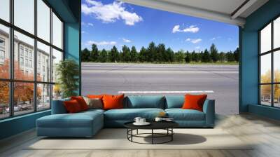 The tarmac road is under blue sky and white clouds Wall mural