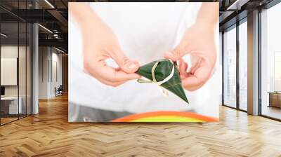 Holding a freshly wrapped zongzi in his hand Wall mural