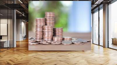 There is a large stack of high dollar coins on the table Wall mural