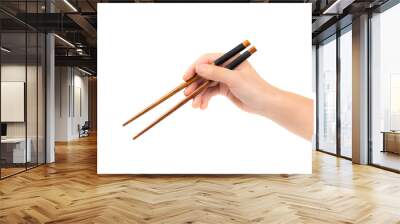 female hand using wooden chopsticks on white background	 Wall mural