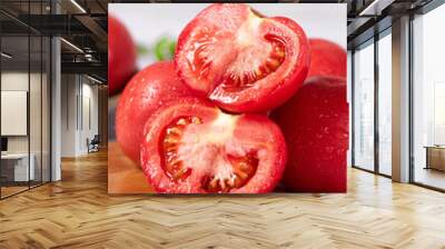 Fresh juicy tomatoes with cut in half on wooden table. Wall mural